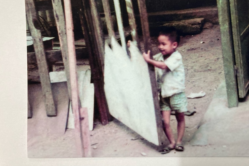 A young boy painting in an orphanage. 