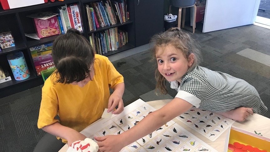 Two girls in a classroom.