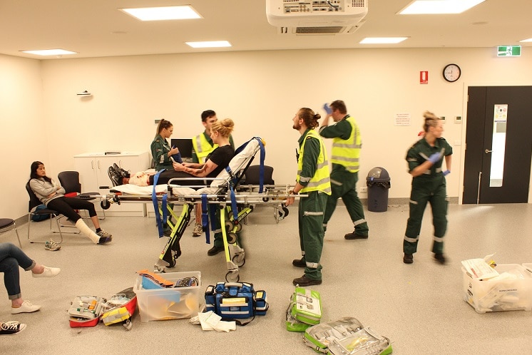 A student is wheeled into the casualty clearing station for treatment