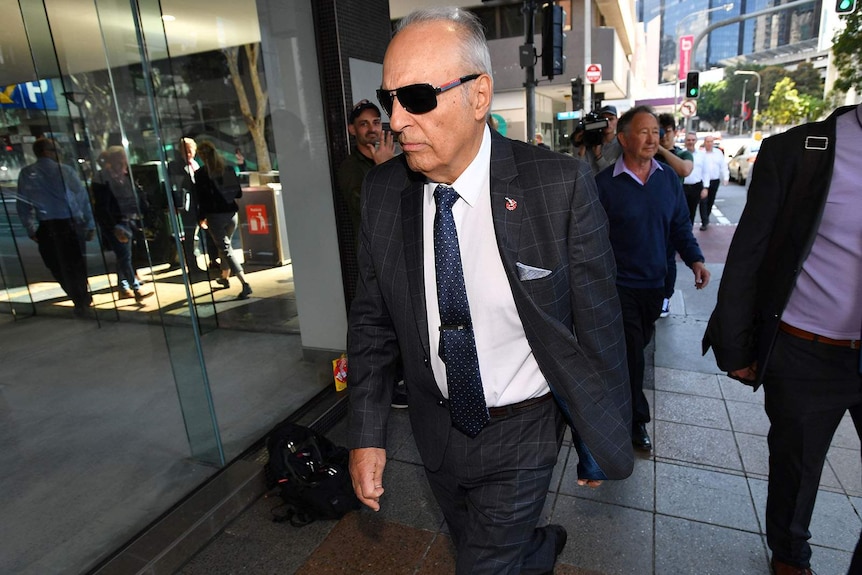Man in sunglasses leaving Royal Commission on Elderly Care in Brisbane