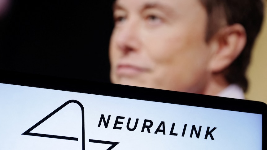 A man in the background of a Neuralink logo 