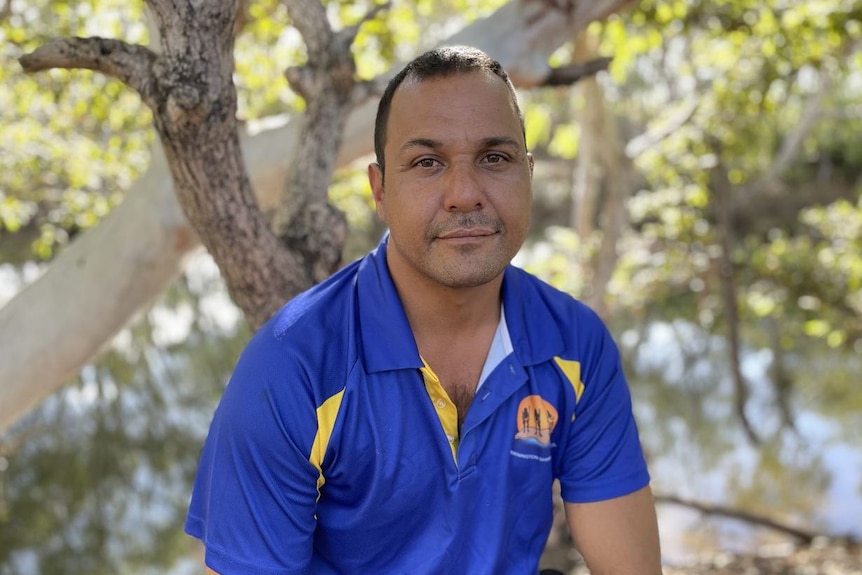 Mornington Island Mayor Kyle Yanner sits and smiles.