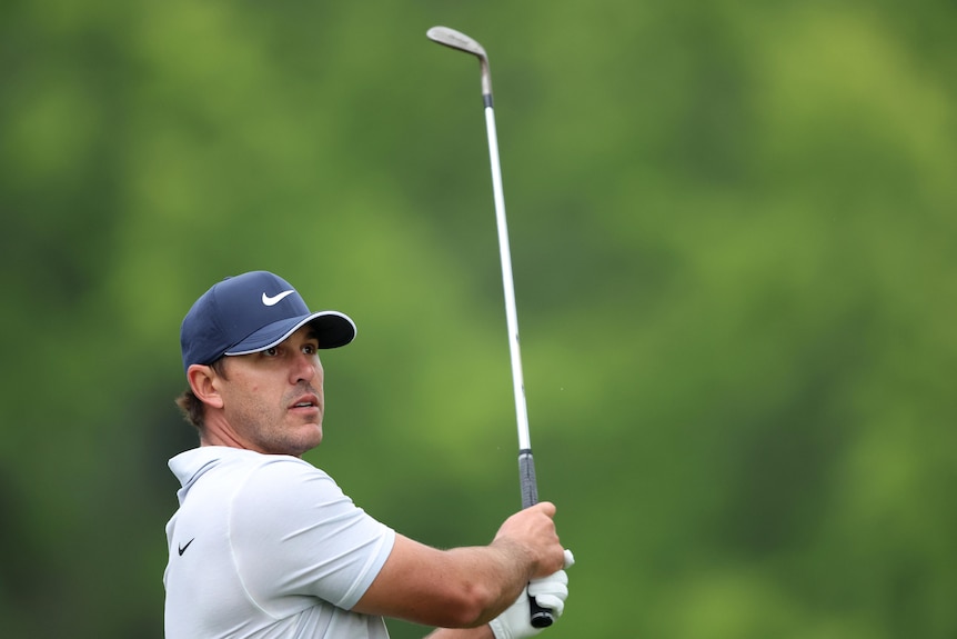Brooks Koepka holds his pose after hitting an iron shot