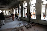 Afghan Municipality workers sweep Baqir-ul Ulom mosque after a suicide attack.