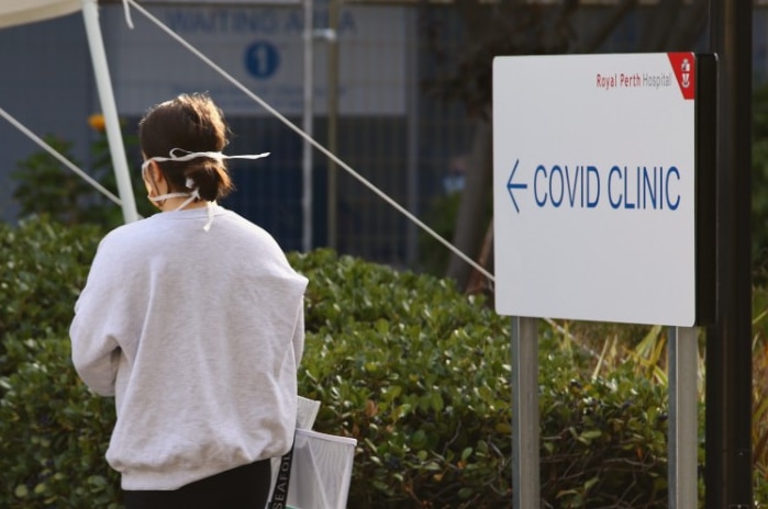 Woman in mask outside a Perth COVID clinic