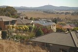 Video still: View of houses at Jerrabomberra near Queanbeyan and Canberra's Telstra Tower in background. April 2013.