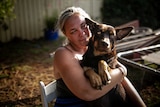 Alisha holds her dog