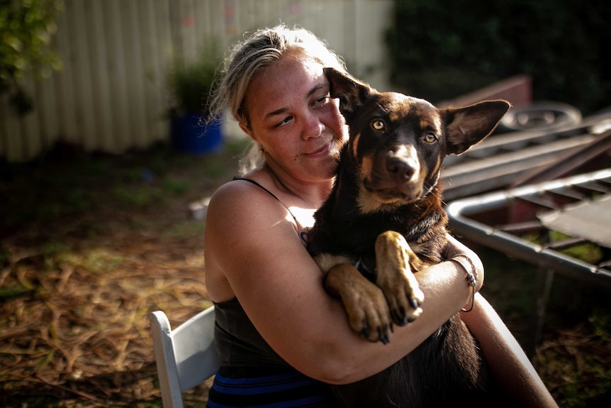 Alisha holds her dog