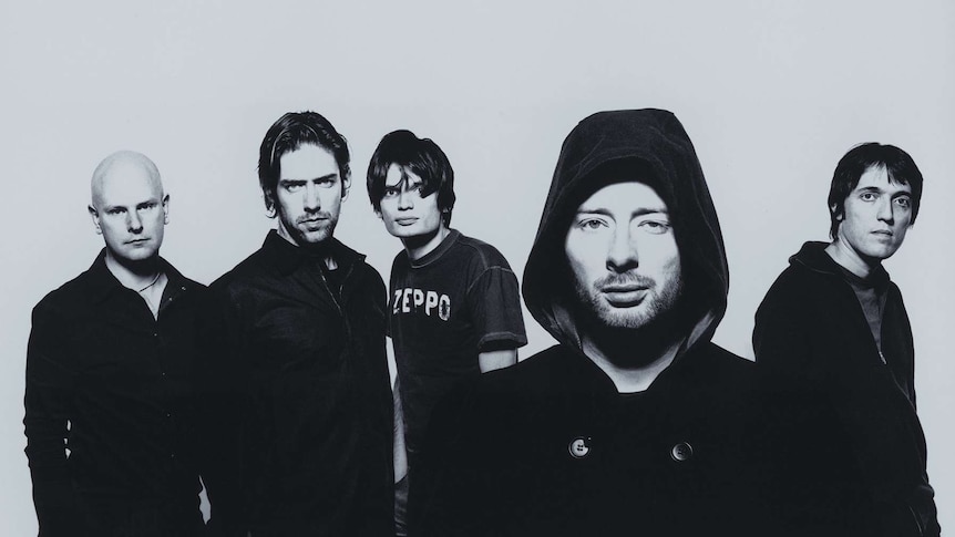 Five band members of Radiohead pose for the camera.
