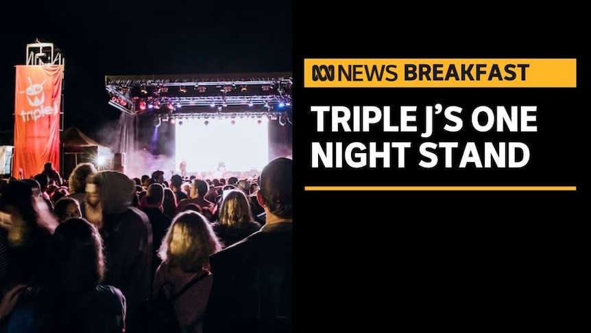 Triple J's One Night Stand: A crowd at an outdoor concert with a triple j banner next to the stage.