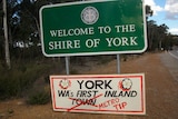 A protest sign describing the Town of York as a tip for the metropolitan area.