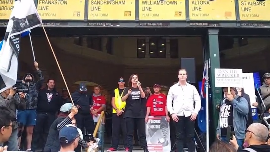 Protesters standing at the entrance of a train station