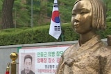 A gold statue of a South Korean woman, part of a monument to those who were subjected to sexual slavery in Japan