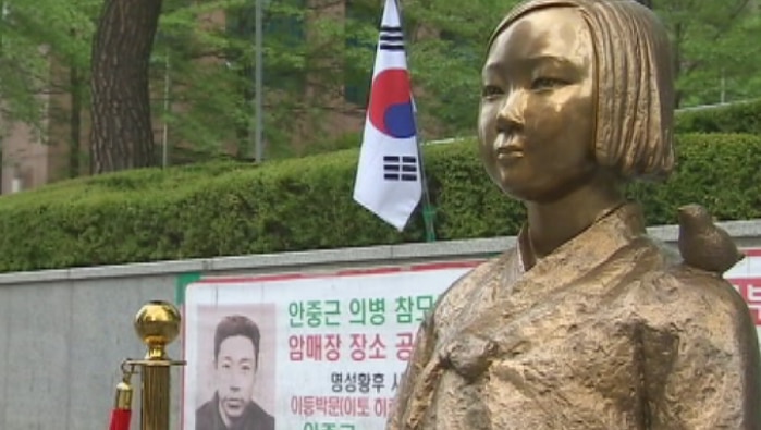 A gold statue of a South Korean woman, part of a monument to those who were subjected to sexual slavery in Japan