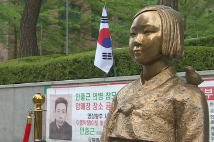 A gold statue of a South Korean woman, part of a monument to those who were subjected to sexual slavery in Japan