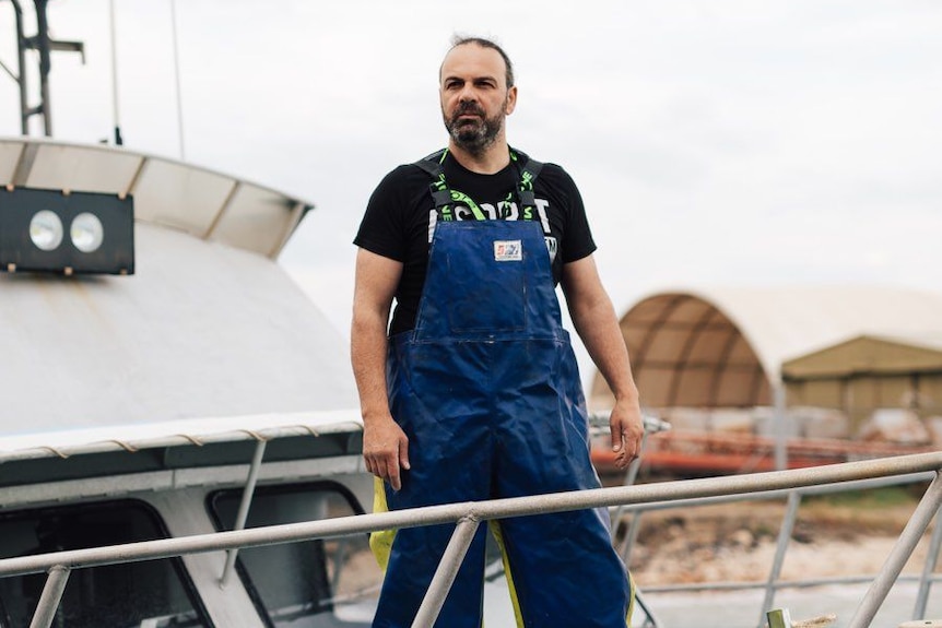 man standing on a fishing boat