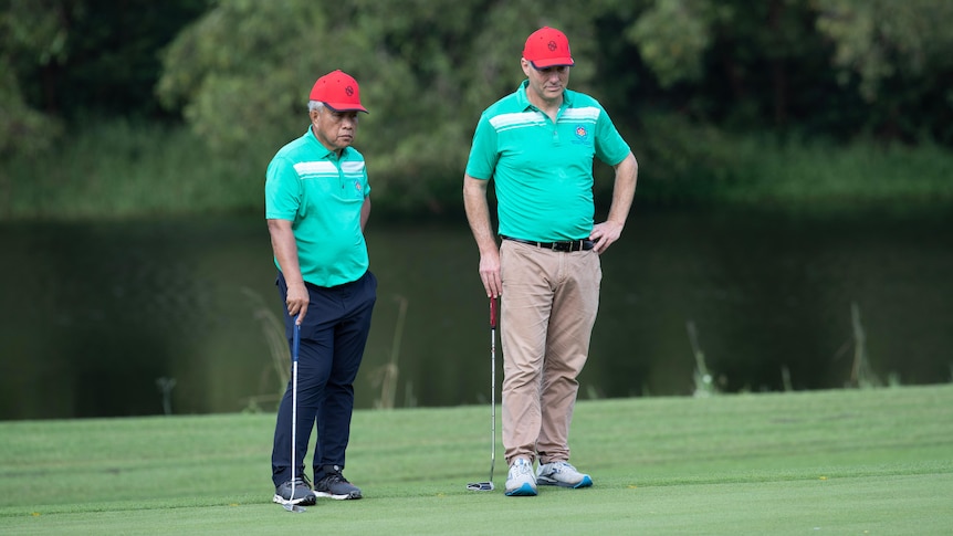 Richard Marles playing golf during a visit to Cambodia 