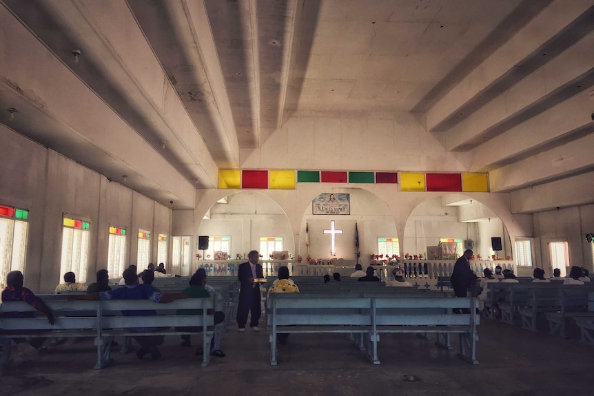 Parishioners gather inside the church on Enewetak Island in the Marshall Island.