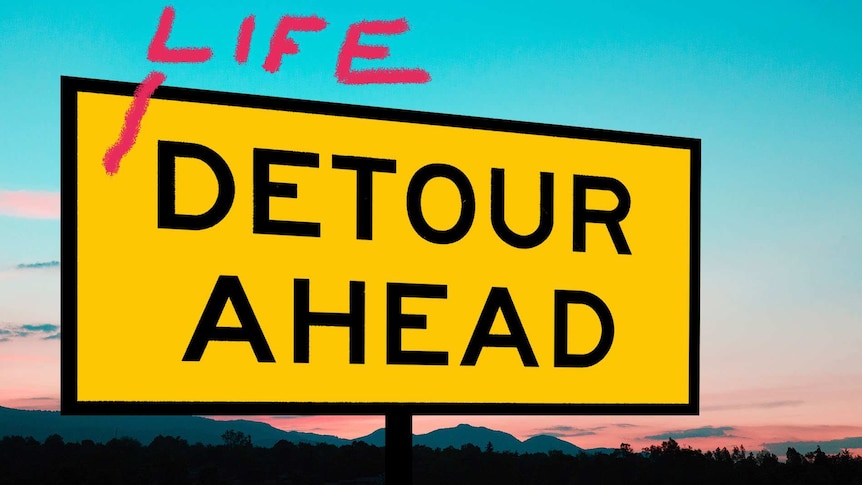 A 'detour ahead' road sign against a sunset horizon.