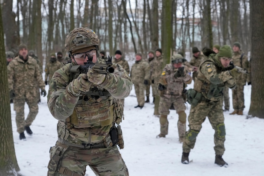 Soldiers in a snow-covered park holding guns.