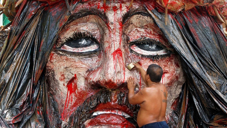 Manuel Revillon, 46, puts finishing touches on an image of Jesus Christ