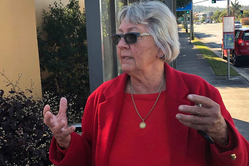 A woman outside a nursing home closed down by Queensland Health
