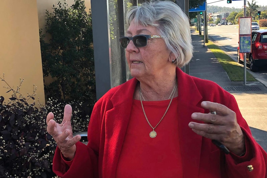 A woman outside a nursing home closed down by Queensland Health