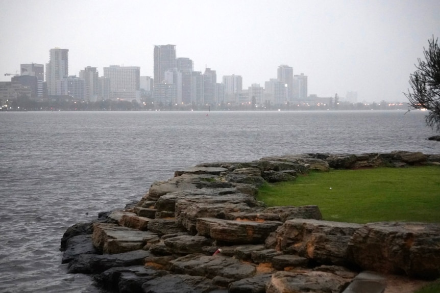 Perth skyline viewed across the river on a rainy day.
