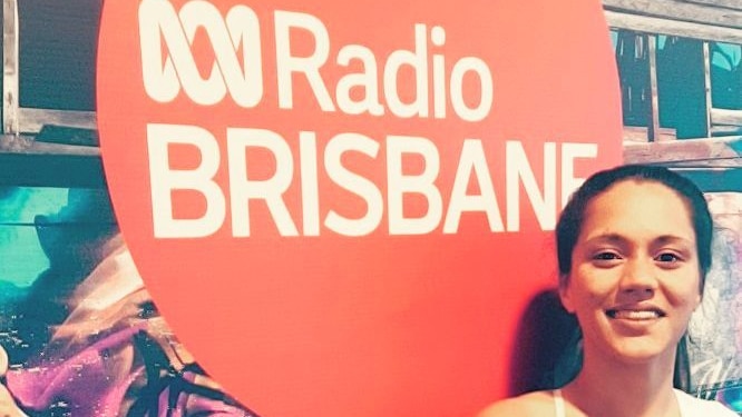 a picture of 21 year old Sarah Paasi in front of the ABC Brisbane Radio sign