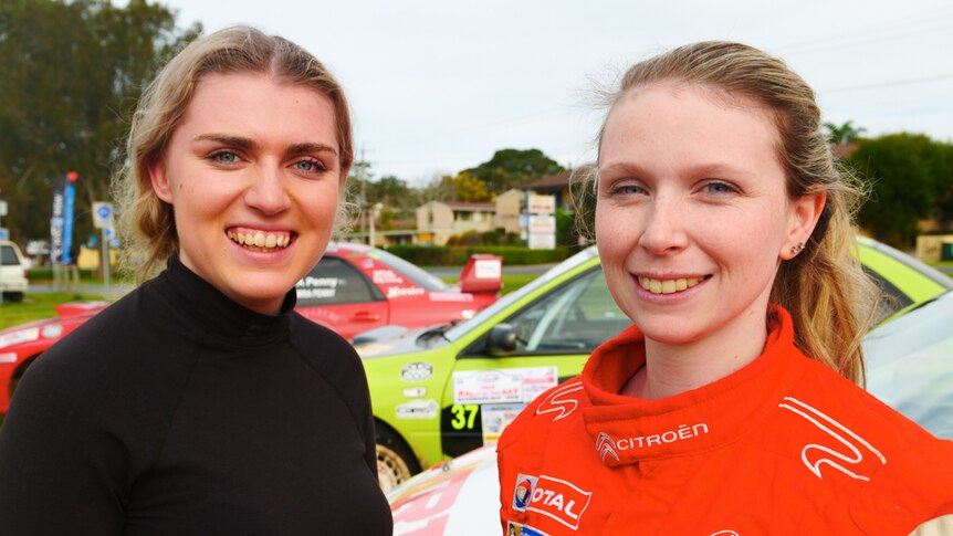 Portrait of two young female rally co-drivers at an event