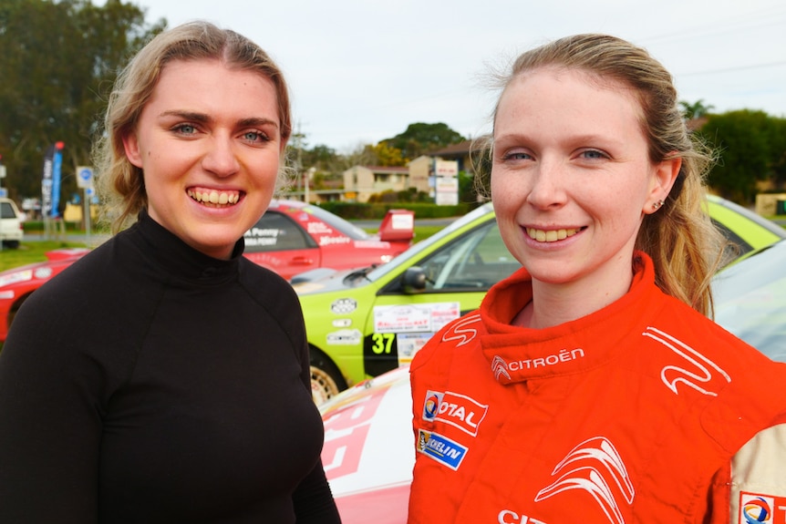 Portrait of two young female rally co-drivers at an event