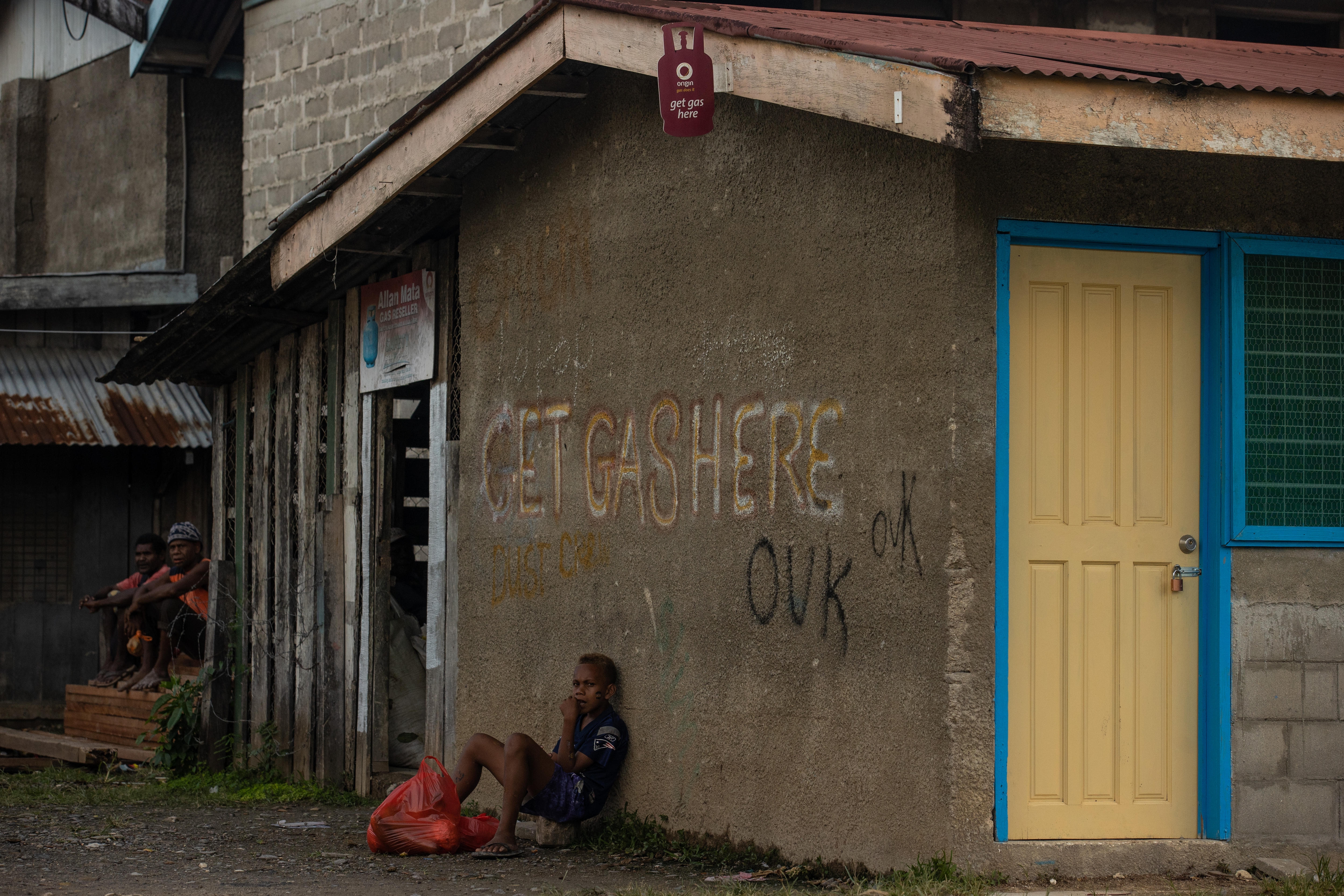 A child leaning against a wall