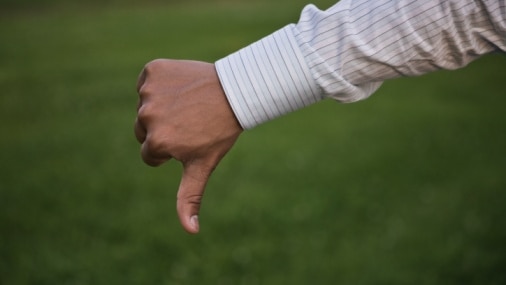 Hand of businessman gesturing thumbs down (Thinkstock: Jupiterimages)