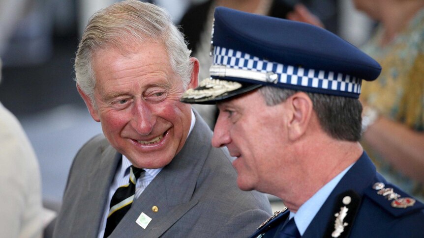 Tight photo of Prince Charles sharing a laugh with Andrew Scipione, Commissioner of the NSW Police Force.