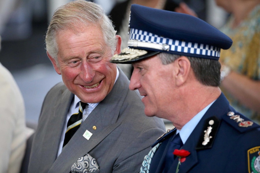 Tight photo of Prince Charles sharing a laugh with Andrew Scipione, Commissioner of the NSW Police Force.