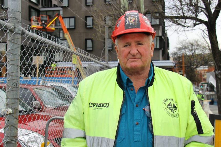 Man wears a hard hat on a construction site
