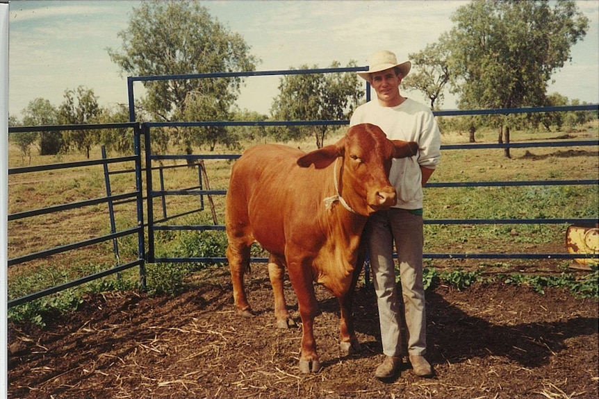 an old photo of a man with a bull