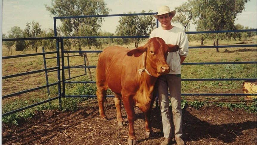 an old photo of a man with a bull
