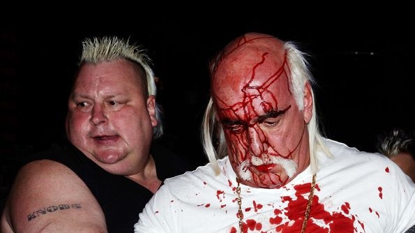 Bloodied Hulk Hogan is escorted by Brian Knobbs (left)
