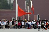 Members of the public watch the flag raising ceremony at Tiananmen Square