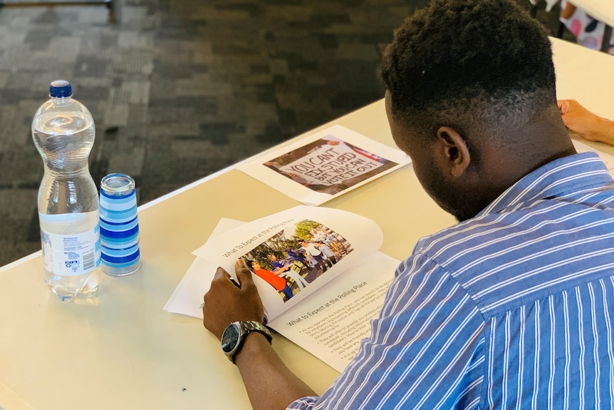 Man reads paperwork on his desk