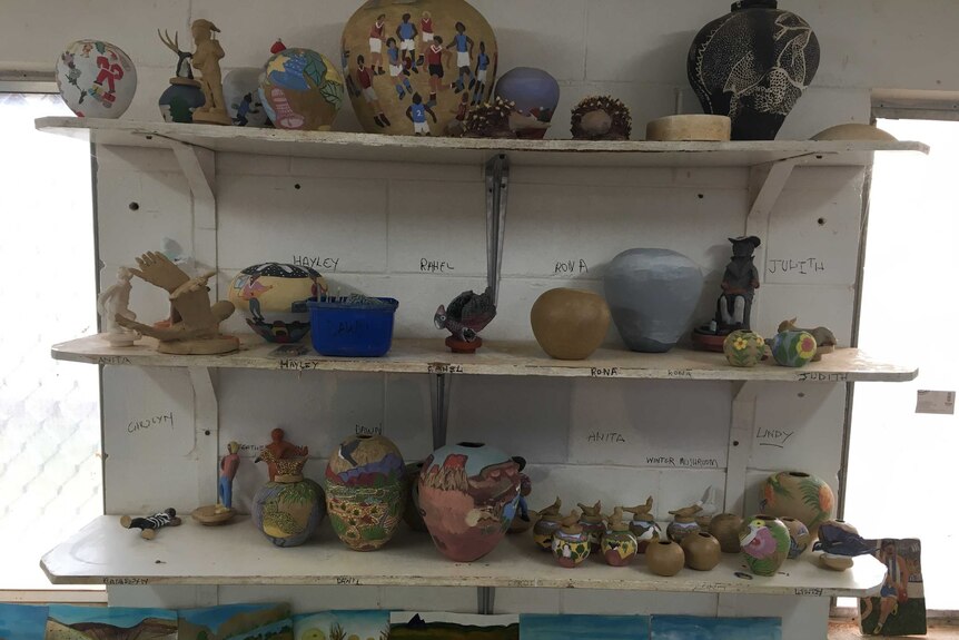 Various pots and art pieces on some shelves at Hermannsburg Pottery