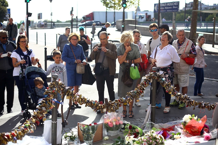 People pay tribute to Diana in Paris. They are standing above the tunnel where she died.