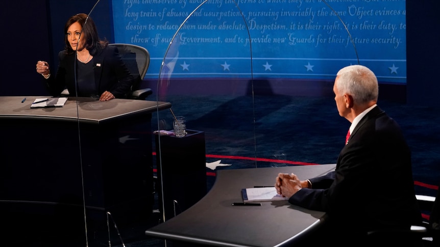 Kamala Harris looks towards Mike Pence through plexiglass during the vice-presidential debate