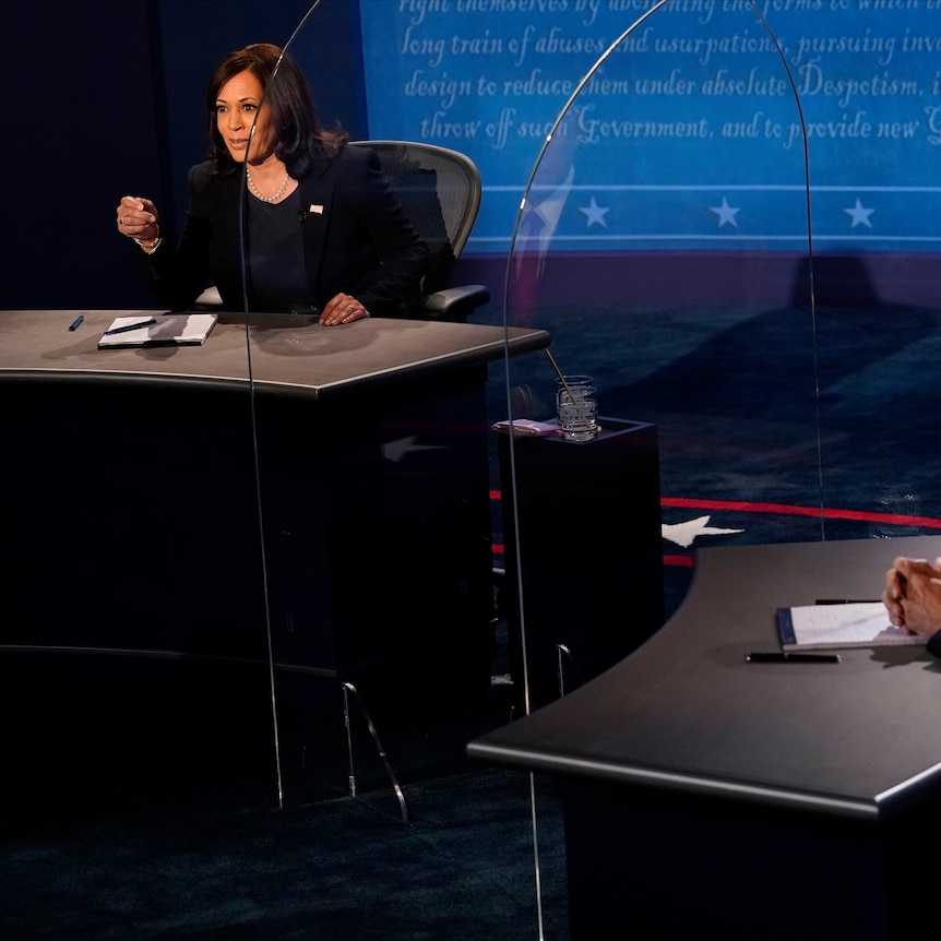 Kamala Harris looks towards Mike Pence through plexiglass during the vice-presidential debate