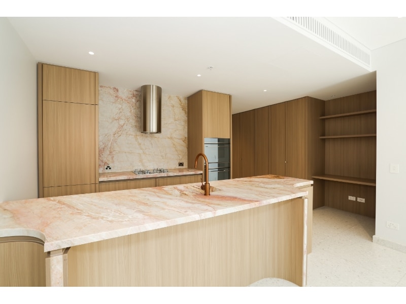 A real estate listings photo shows the kitchen of a new luxury apartment.