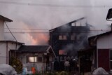 Smoke billows from a house in Japan.