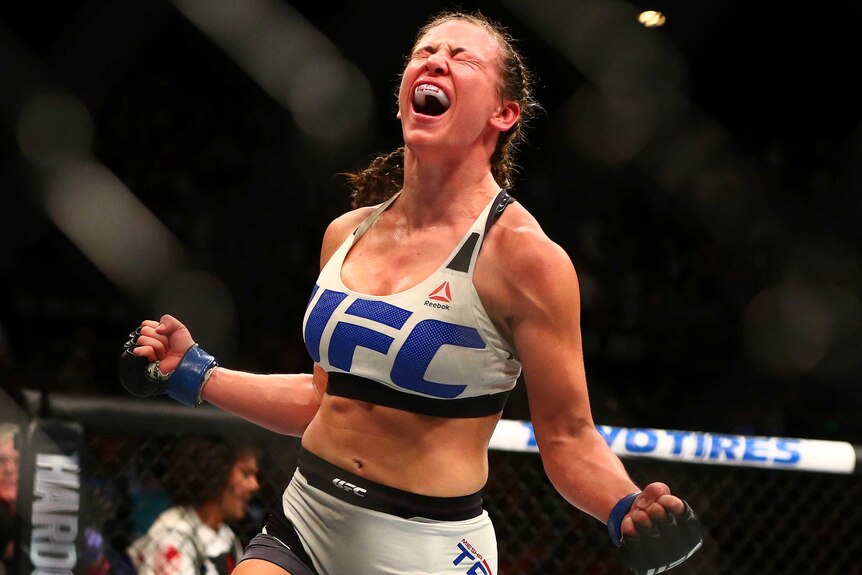 Miesha Tate celebrates her victory by submission over bantamweight champion Holly Holm at UFC 196.