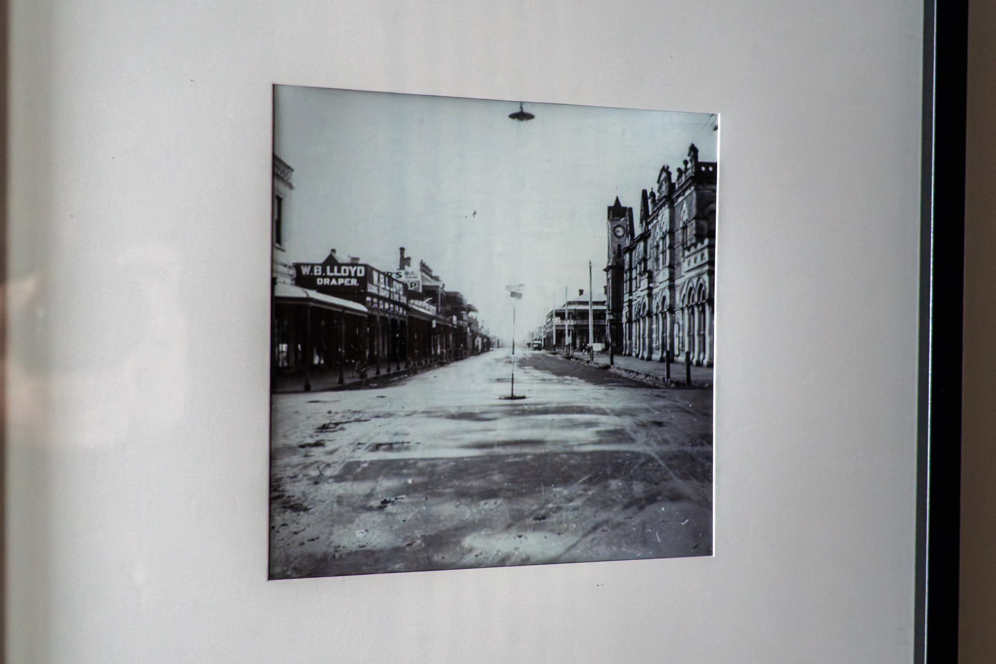 A black and white photo showing the main street of an old country town