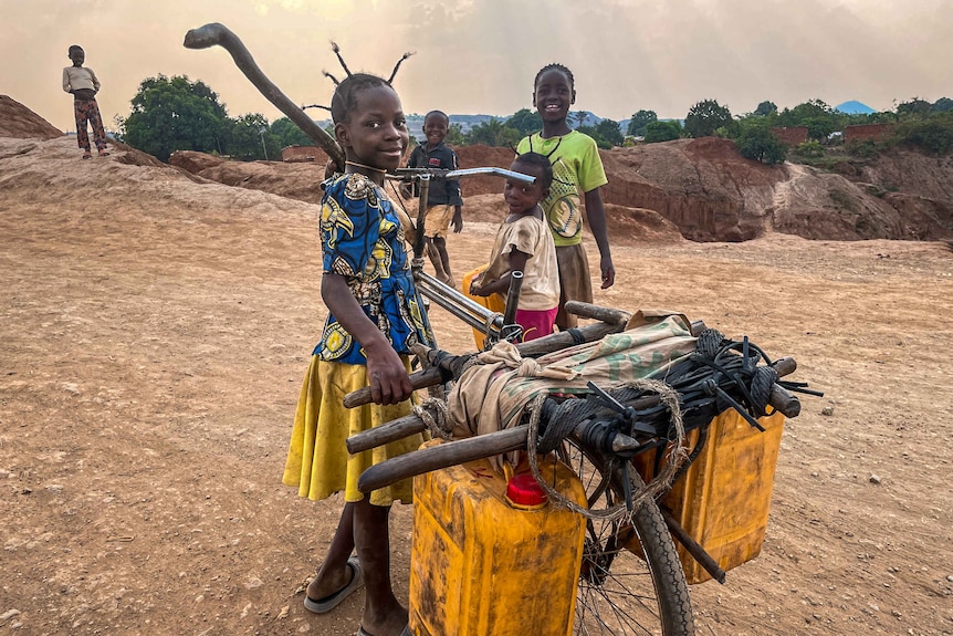 A young girl with a bike.